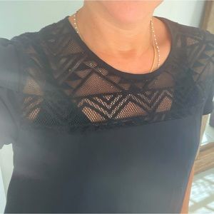 Black top with patterned mesh and tulip sleeves